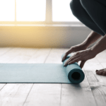 Person rolling up a yoga mat