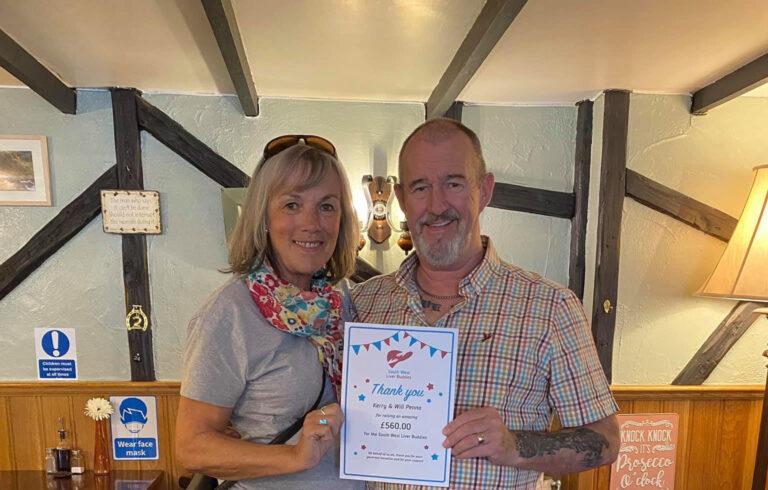 Photograph of Treasurer Josie Eddy handing a thank you certificate to Will Penno for fundraising money for the South West Liver Buddies
